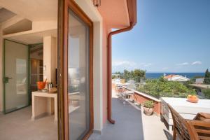 a balcony with a view of the ocean at Delmare Tower View Suites in Nea Fokea