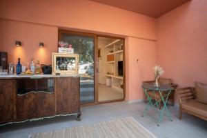 a room with a counter and a table and a chair at Delmare Tower View Suites in Nea Fokea