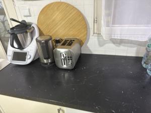 a kitchen counter top with a toaster and a coffee maker at Thechillhome in Tigery