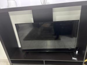 a flat screen tv sitting on top of a shelf at Thechillhome in Tigery