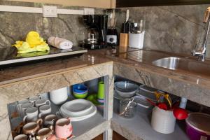 a kitchen counter with a sink and some dishes at Cabaña Timarama in Fortuna +23 photos