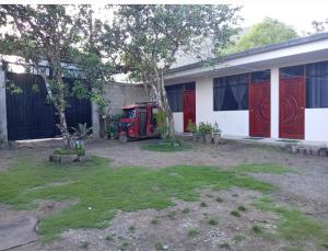 a red truck parked in front of a house at HSPEDAJE Mathew & Gael in Tingo María