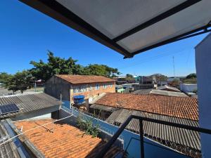 a view from the balcony of a building with red tile roofs at Flat completo a 24 minutos do Flamboyant Shopping in Aparecida de Goiania