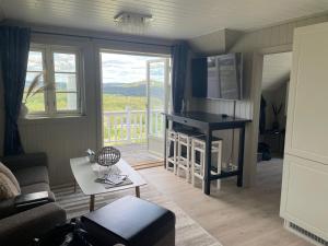 a living room with a couch and a table at Sjåen Panorama in Kragerø