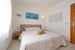 a bedroom with a bed with a stuffed animal on it at Vista Divina in Cumbre del Sol +103 photos