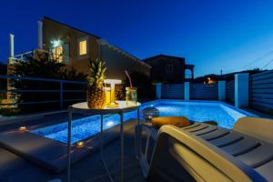 patio con tavolo e piscina di notte di Villa "Amber" relaxation in nature with a Pool a Mlini