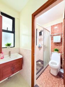 a bathroom with a shower and a toilet and a sink at Theraistays in Nairobi +9 photos