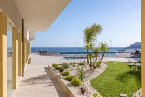a view of the beach from a balcony of a resort at Sea&Cliffs - Stunning Seaview Luxury apartment in Sesimbra