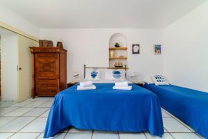 a bedroom with two beds with blue sheets at Casa di Zia Rosaria SEA VIEW in Vietri sul Mare
