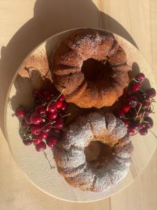 two donuts and berries on a plate on a table at SEA & LAKE VIEW VILLA in (( Kalive Gjoka ))