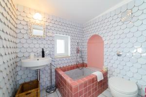 a bathroom with a sink and a tub and a toilet at Casa di Zia Rosaria SEA VIEW in Vietri sul Mare