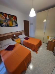 a hotel room with two beds in a room at Affittacamere Girasole in Foligno