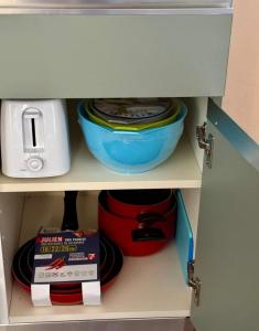 a cabinet with some bowls and a toaster and a box at Historic Old Townhouse in center of Chieti in Chieti