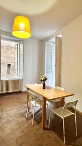 a dining room with a wooden table and chairs at Historic Old Townhouse in center of Chieti in Chieti