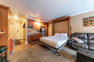 a bedroom with a bed and a couch in a room at Cozy Deluxe Studio #131 at Donner Lake Village condo in Truckee