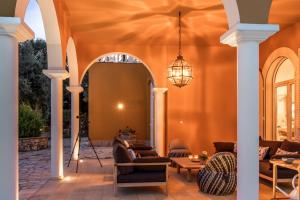 an outdoor living room with a chandelier at Kronos Estate Lefkada - 5 star luxury in Mikros Gialos