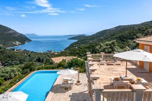 a villa with a swimming pool and a view at Kronos Estate Lefkada - 5 star luxury in Mikros Gialos