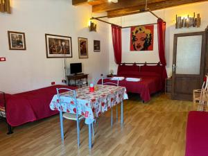 a living room with a table and a bed and a bedroom at La Meridiana Bed & Bike in Celico