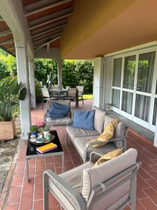 a patio with couches and a table on a porch at Casa "Le Rondinelle" in Montignoso
