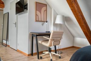 a bedroom with a desk and a chair at Eagle Suite Charmante Dachgeschosswohnung mit Design & Ausblick in Zurich