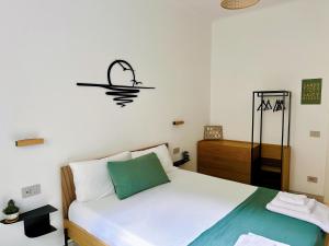 a bedroom with a bed and a sign on the wall at Salty Suite in Levanto