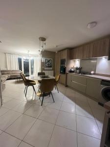 a kitchen and living room with a table and chairs at Mason Gardens Home in Chilton