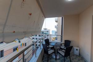 a balcony with a table and chairs on it at Spacious 2 bedroom apartment in Durres Beach in Durrës