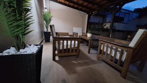 a patio with chairs and a table and potted plants at Apartments & Dream Rooms in Niš