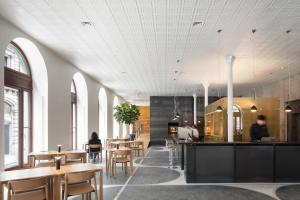 a restaurant with tables and chairs and people sitting at tables at Hotel Gault in Montreal