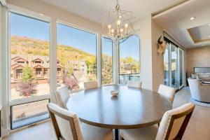 a dining room with a table and chairs and a large window at Luxury Townhome with Spectacular Views. Private Hot Tub & Walking Distance to Main Street - in Park City
