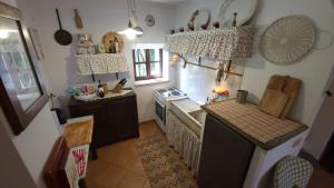 a kitchen with a sink and a stove top oven at Casa Laura in Madonna della Scala