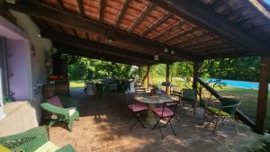 a patio with chairs and a table and a grill at Casa Laura in Madonna della Scala