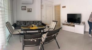 a living room with a table and chairs and a couch at Aegean dream house in Ofrínion