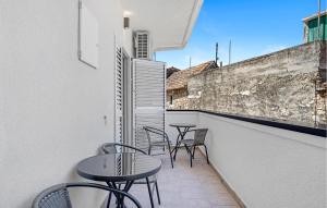 a balcony with tables and chairs on a building at Nice Apartment In Vodice With Wifi in Vodice