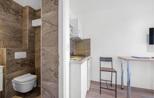 a bathroom with a toilet and a sink and a stool at Nice Apartment In Vodice With Wifi in Vodice
