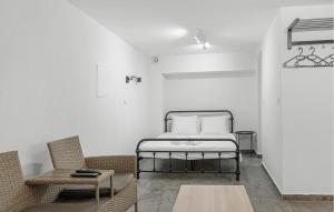 a bedroom with a bed and a couch and a table at 1 Bedroom Stunning Apartment In Vodice in Vodice