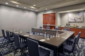 a conference room with tables and chairs and a podium at Courtyard Culver City Los Angeles in Los Angeles