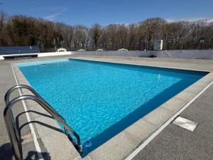 a large blue swimming pool in a parking lot at The Green - Summer Breeze in Crantock