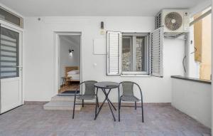 a table and chairs in a kitchen with a window at 1 Bedroom Nice Apartment In Vodice in Vodice
