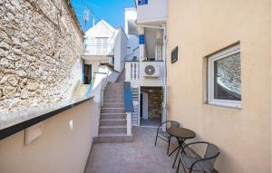 a narrow alley with chairs and a table in a building at 1 Bedroom Nice Apartment In Vodice in Vodice