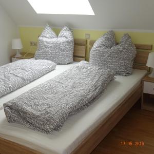 a bed with two pillows on top of it at Hotel Einstein in Bad Krozingen