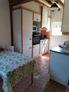a kitchen with a table and a counter top at Le Presbytère - La Trêverie in Le Torquesne +9 photos