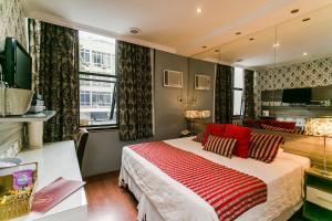 a bedroom with a large bed with red pillows at Social Hostel in Rio de Janeiro