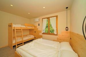 a bedroom with two bunk beds and a window at La Fontanina in Vobarno +55 photos