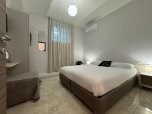 a bedroom with a large bed and a window at Paola HOME in Varazze