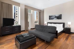 a bedroom with a bed and a couch and a tv at Hotel 57 in New York