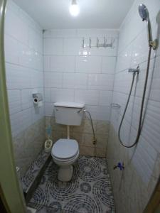 a bathroom with a toilet and a shower at muffler motel bukesa in Kampala