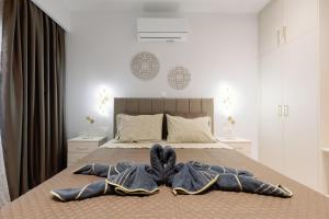 a bed with two pairs of jeans on it at City Pearl in Kos Town