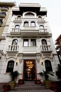a large white building with a clock on the front of it at Hotel Niles Istanbul in Istanbul