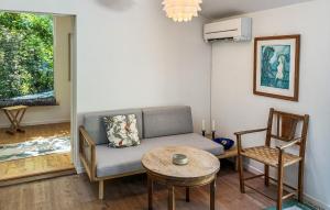 a living room with a couch and a table at 3 Bedroom Cozy Home In Vejby in Vejby